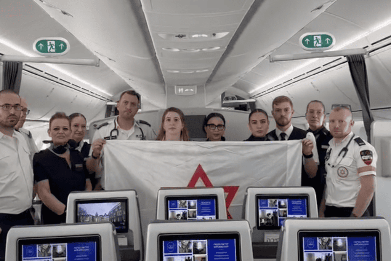Members of Magen David Adom on El Al plane en route to Amsterdam to bring back Israeli citizens. Source: Screenshot.